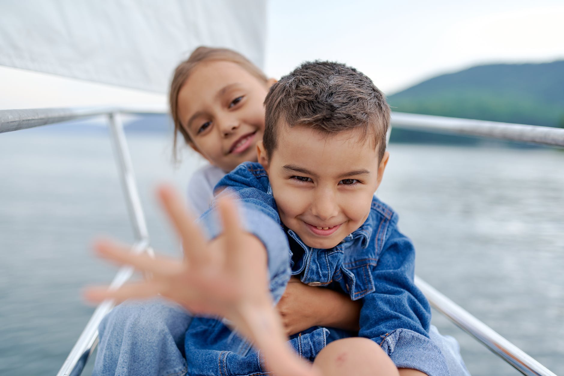 happy little boy reaching hand on camera