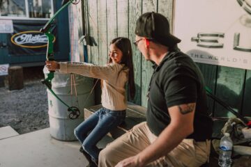 a girl holding an archery bow